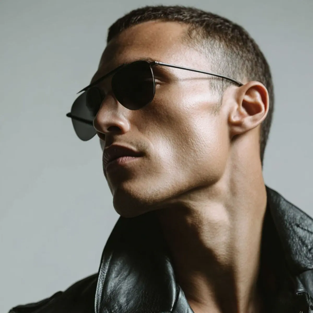 Man in profile wearing aviator sunglasses