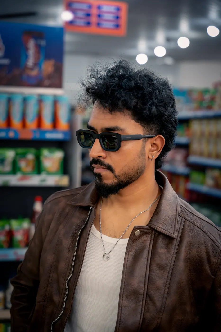 Man in a brown leather jacket wearing wooden retro sunglasses