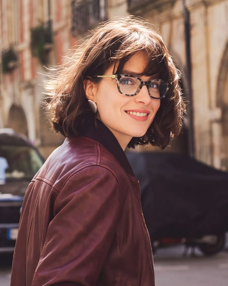 Woman wearing eyeglasses in a burgundy jacket